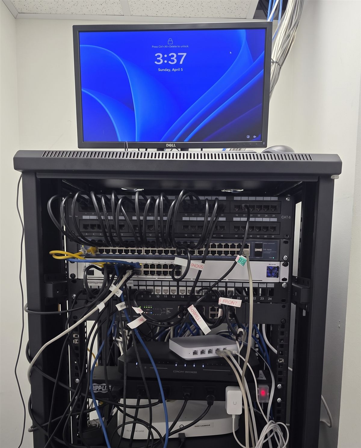 Before: tangled, unlabeled cabling in the same South Florida office network rack